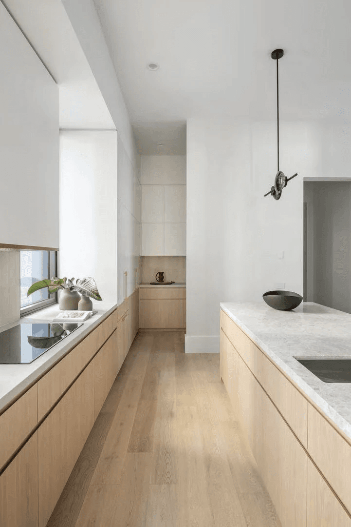 Kitchen visualisation showing a long worktop and island arrangement.
